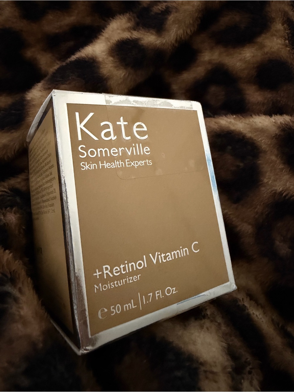 Kate Somerville Moisturizer in tan and silver Packaging